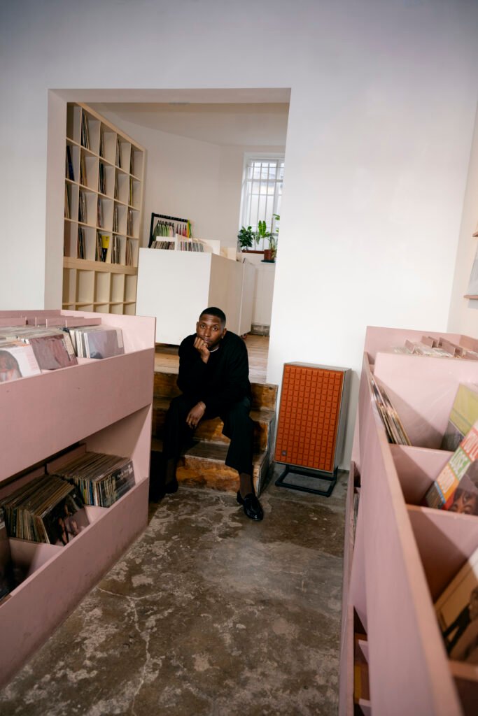 A photo of Samm Henshaw in a record store